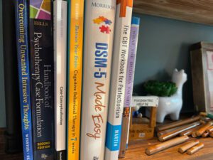 Psychology books on shelf in therapist office